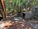 Backyard with red brick patio featuring a built-in brick grill and steps to an upper level at 209 Jungle Rd, Edisto Beach, SC 29438