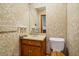Small bathroom featuring patterned wallpaper, vanity, toilet, and neutral countertop at 209 Jungle Rd, Edisto Beach, SC 29438