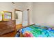 Bedroom with wood floors, bed, chest of drawers and white walls at 209 Jungle Rd, Edisto Beach, SC 29438