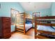 Bedroom with blue walls offers two sets of wooden bunk beds and chest of drawers at 209 Jungle Rd, Edisto Beach, SC 29438
