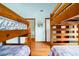 Bedroom with blue walls offers two sets of wooden bunk beds and hardwood floors at 209 Jungle Rd, Edisto Beach, SC 29438