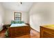 Bedroom with wood floors, bed, window with wooded view and white walls at 209 Jungle Rd, Edisto Beach, SC 29438