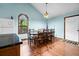 Dining area with large table, chairs, and bright natural light from window at 209 Jungle Rd, Edisto Beach, SC 29438