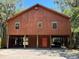 Charming stilt home with wood siding, a vibrant front door, and ample covered parking, blending style and functionality at 209 Jungle Rd, Edisto Beach, SC 29438