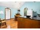 Open space includes a dining area, tv, and a peninsula with dark granite countertop at 209 Jungle Rd, Edisto Beach, SC 29438