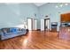Open living room area, hardwood floors, lots of natural light, and many entry points to other rooms at 209 Jungle Rd, Edisto Beach, SC 29438