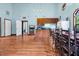 Open-concept living space with kitchen, dining area, and light blue walls at 209 Jungle Rd, Edisto Beach, SC 29438