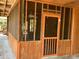 A portion of a screened porch shows the wood framed walls, ceiling, and an access door at 209 Jungle Rd, Edisto Beach, SC 29438