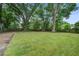 Large backyard featuring lush green lawn and mature trees at 2135 Clayton St, Charleston, SC 29414