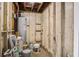 Unfinished basement featuring hot water heater, exposed beams, and paint storage at 2135 Clayton St, Charleston, SC 29414