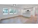 Open-concept living area featuring wood floors, bright windows, and a modern kitchen with a center island at 2135 Clayton St, Charleston, SC 29414