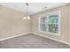 Bright dining area with chandelier and large window view to a wooded exterior at 2244 Ashley Crossing Dr # 534, Charleston, SC 29414