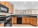 Open concept kitchen with stainless steel sink, black appliances and wooden cabinets at 2244 Ashley Crossing Dr # 534, Charleston, SC 29414