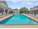Beautiful community pool surrounded by lounge chairs and an inviting clubhouse for relaxation at 2244 Ashley Crossing Dr # 534, Charleston, SC 29414