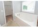 Bright bathroom features a soaking tub and walk-in closet at 228 Donatella Dr, Goose Creek, SC 29445