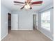 Bedroom with neutral walls, plush carpet, ceiling fan, and ample closet space at 228 Donatella Dr, Goose Creek, SC 29445