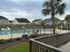A refreshing community pool area is surrounded by a fence and palm trees at 228 Donatella Dr, Goose Creek, SC 29445