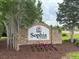 Community welcome sign at Sophia Landing with flowers at 228 Donatella Dr, Goose Creek, SC 29445