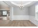 Dining room with carpet, chandelier, wainscoting, and large windows that bring in sunlight at 228 Donatella Dr, Goose Creek, SC 29445