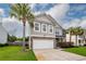 Charming two-story home featuring a two-car garage, stone accents and lush, green landscaping at 228 Donatella Dr, Goose Creek, SC 29445