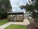 Gazebo in community with pool in background, perfect for parties and gatherings at 228 Donatella Dr, Goose Creek, SC 29445