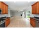 Kitchen with stainless appliances opens to living area with sliding door to patio and fireplace at 228 Donatella Dr, Goose Creek, SC 29445