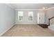 Open living room with hardwood entryway, neutral carpet, and natural light from the window at 228 Donatella Dr, Goose Creek, SC 29445