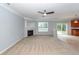 Living room with ceiling fan, fireplace, and window with a view of the backyard at 228 Donatella Dr, Goose Creek, SC 29445