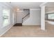 Living room featuring neutral carpet, staircase, pillars, and open layout, perfect for gatherings at 228 Donatella Dr, Goose Creek, SC 29445