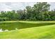 The view from the grassy shoreline to a clear, spring-fed pond, ready for relaxing days at 228 Donatella Dr, Goose Creek, SC 29445