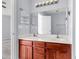 Bathroom vanity with a dual sink, large mirror, and wood cabinets for storage at 230 Darcy Ave, Goose Creek, SC 29445