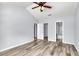 Spacious bedroom with a ceiling fan, wood floors, and multiple closets for ample storage at 230 Darcy Ave, Goose Creek, SC 29445
