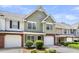 Inviting townhouse featuring a single-car garage, complemented by attractive landscaping and charming curb appeal at 230 Darcy Ave, Goose Creek, SC 29445