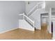 Inviting foyer displays hardwood floors and a staircase with white wooden banisters at 230 Darcy Ave, Goose Creek, SC 29445
