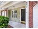 Close-up of the front door with a black door, a side window, and the house number on the exterior at 230 Darcy Ave, Goose Creek, SC 29445