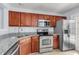 Modern kitchen with stainless steel appliances, granite counters, and wood cabinets at 230 Darcy Ave, Goose Creek, SC 29445
