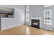 Open concept living room featuring a fireplace, hardwood floors and adjoined kitchen at 230 Darcy Ave, Goose Creek, SC 29445