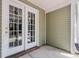 Screened in porch with sliding glass doors and view into the home via the French doors at 230 Darcy Ave, Goose Creek, SC 29445