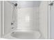 Close-up of a clean, white shower tub with a modern showerhead and built-in shelving at 230 Darcy Ave, Goose Creek, SC 29445