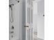 Close-up of a clean, white shower and showerhead, and a stairwell in the background at 230 Darcy Ave, Goose Creek, SC 29445