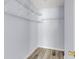 Bright walk-in closet featuring clean, white walls and built-in shelving for organization at 230 Darcy Ave, Goose Creek, SC 29445