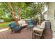 Inviting back deck featuring outdoor seating, a grill, and a lush, tree-filled backyard at 261 Mossy Oak Way, Mount Pleasant, SC 29464