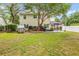 Spacious backyard with mature trees and a playhouse, offering plenty of room to relax and play at 261 Mossy Oak Way, Mount Pleasant, SC 29464