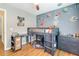 A bedroom with space themed decorations, a loft bed, desk, and gray dresser at 261 Mossy Oak Way, Mount Pleasant, SC 29464
