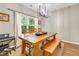 Charming dining room with wood table, bench seating and modern light fixture at 261 Mossy Oak Way, Mount Pleasant, SC 29464