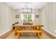 Bright dining room features modern light fixture and wood table with bench seating at 261 Mossy Oak Way, Mount Pleasant, SC 29464