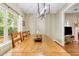 Bright dining room features a large wooden table, modern lighting, and view of the living area at 261 Mossy Oak Way, Mount Pleasant, SC 29464