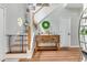Inviting foyer with staircase, light gray walls, hardwood floors and rustic wood accents at 261 Mossy Oak Way, Mount Pleasant, SC 29464