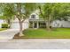 Traditional home with a manicured lawn, mature trees, and a welcoming front porch at 261 Mossy Oak Way, Mount Pleasant, SC 29464