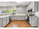 Well-lit kitchen boasts stainless appliances, white countertops, and modern finishes at 261 Mossy Oak Way, Mount Pleasant, SC 29464